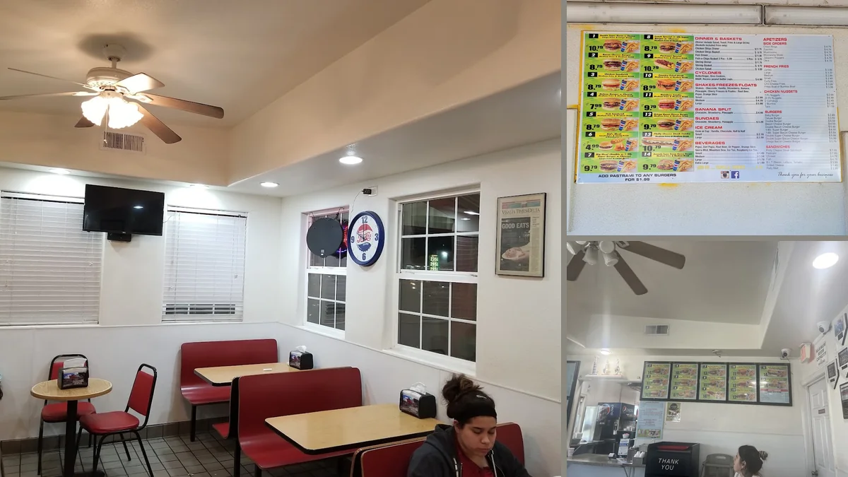 Drive-through lane beside a low roadside diner.