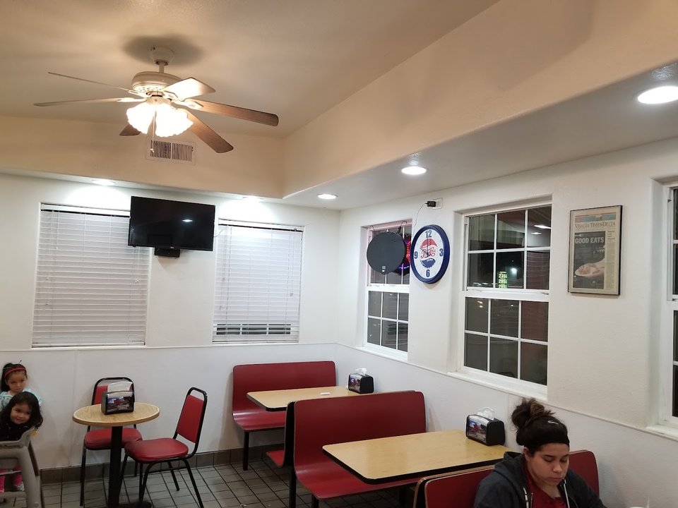 Drive-through lane beside a low roadside diner.