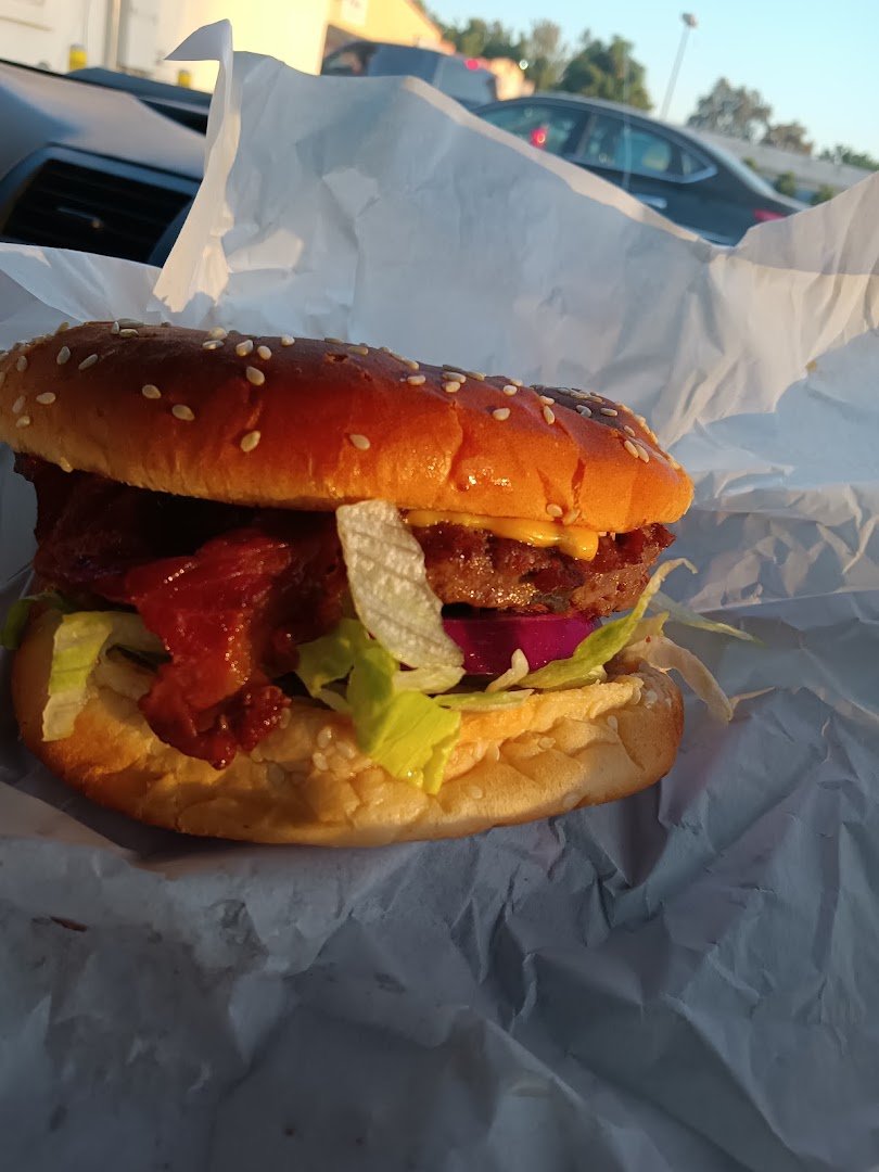 Golden fries beside a burger on a tray.